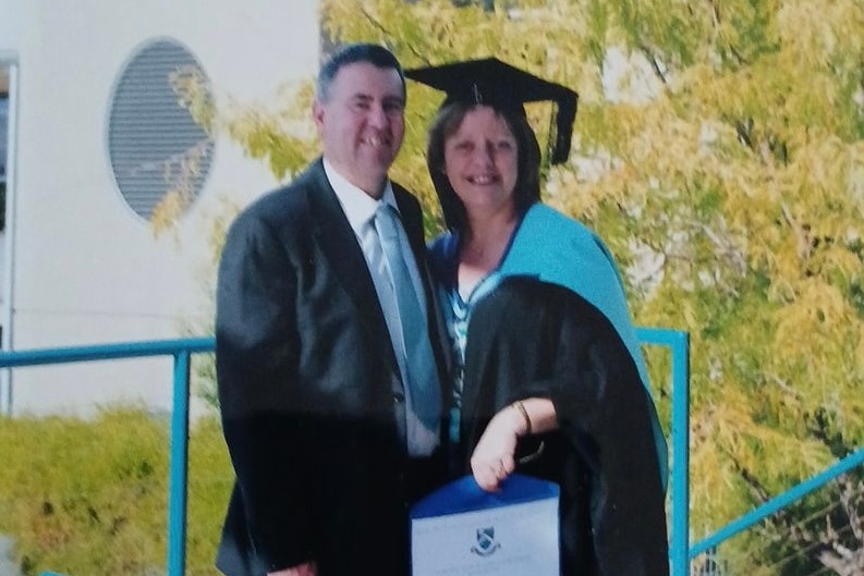 a woman holding her diploma